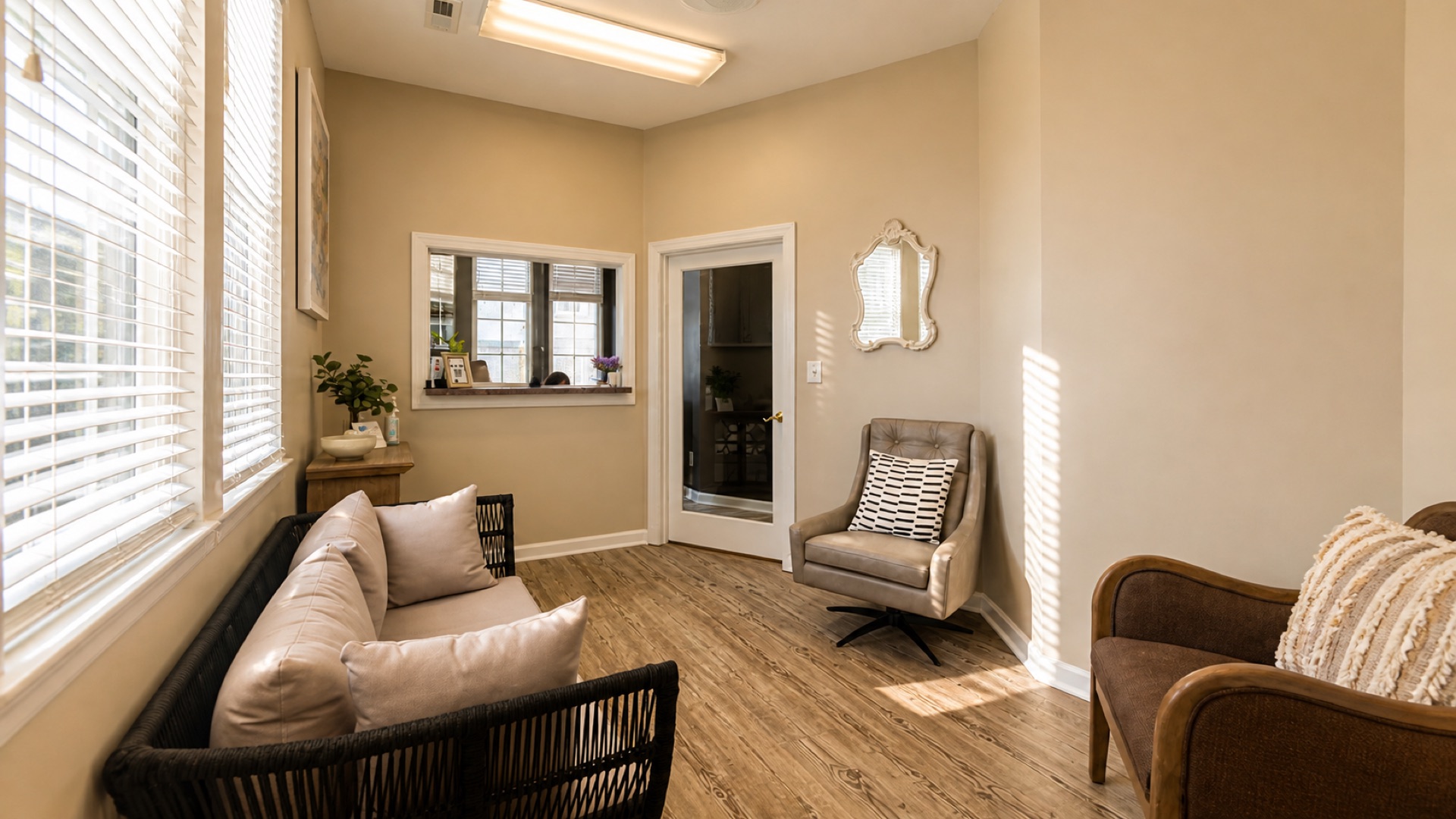 Reception and patient waiting area at Roanoke Dental Center — soft seating, hardwood floors, natural light through blinds